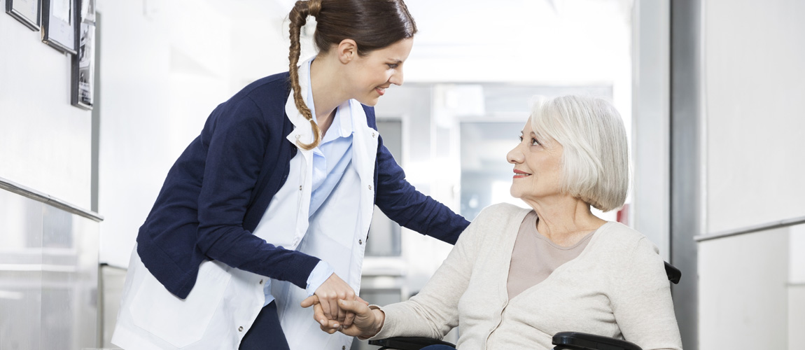 Nurse with elderly woman in long term care facility