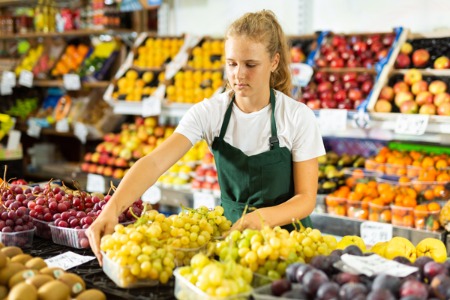 teenage girl working in grocery store