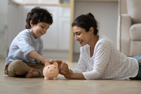 Mom and son with piggy bank
