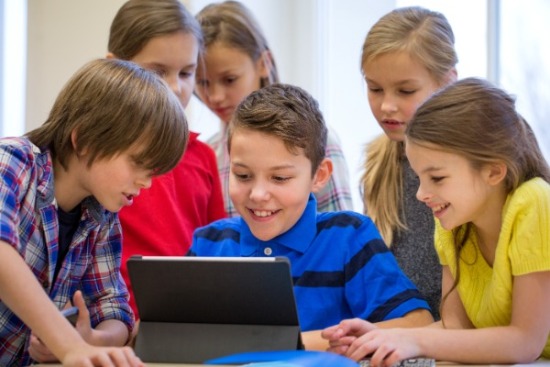 Kids looking at an ipad