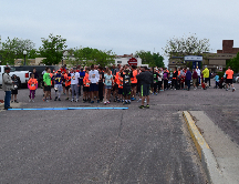 Group in parking lot near starting line for race