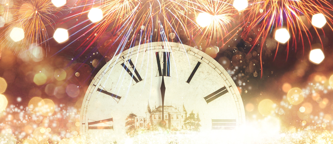 clock at midnight with fireworks