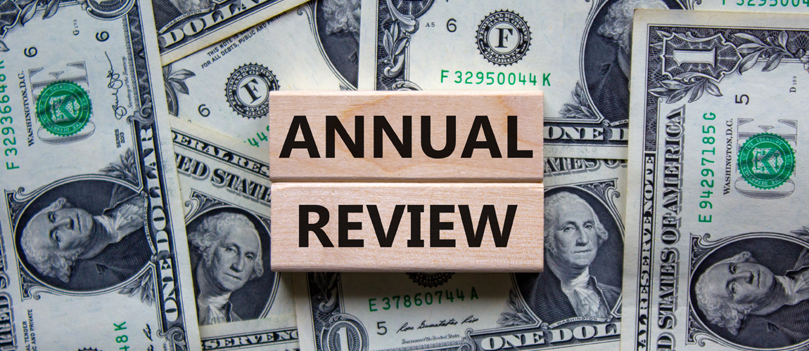 Annual review with dollar bills around the words