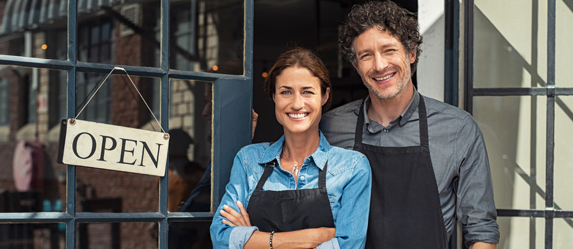 Business owners standing outside of their store