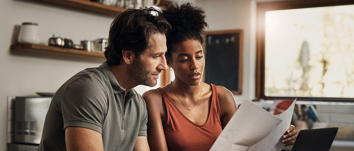 Couple sitting together reviewing documents