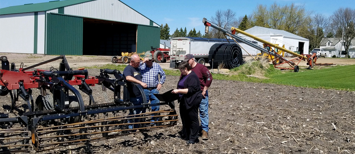 Agent, Jen Eager, talking to farmers about farm insurance