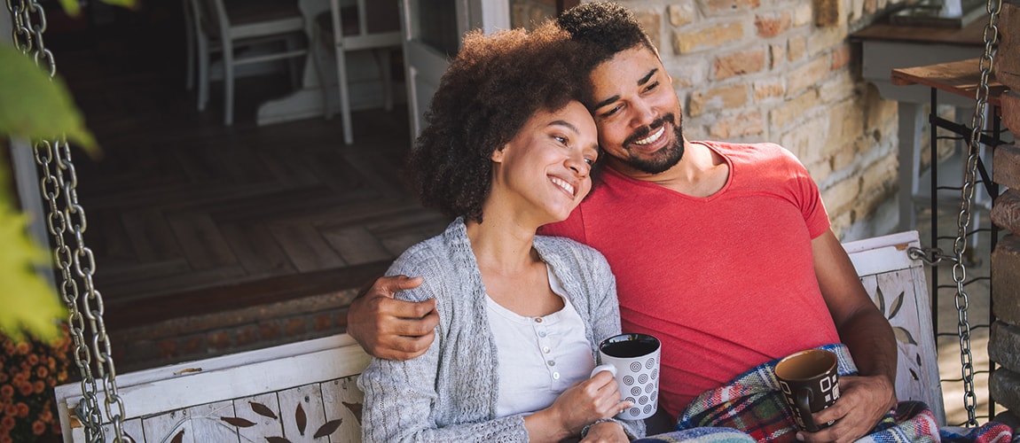 Young couple sitting on porch