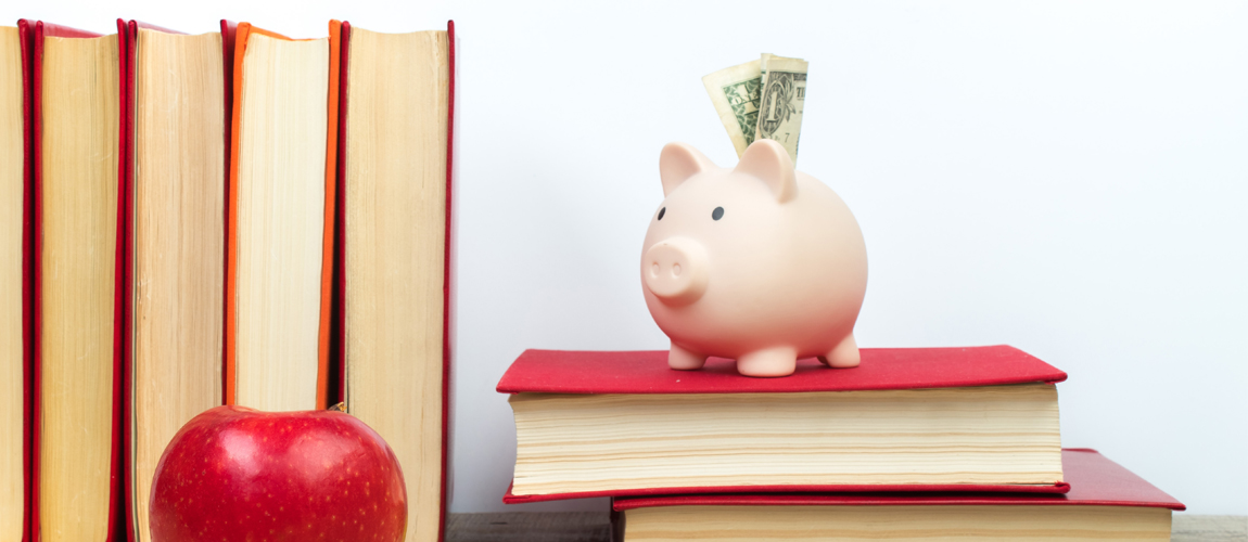 piggy bank sitting on a pile of books