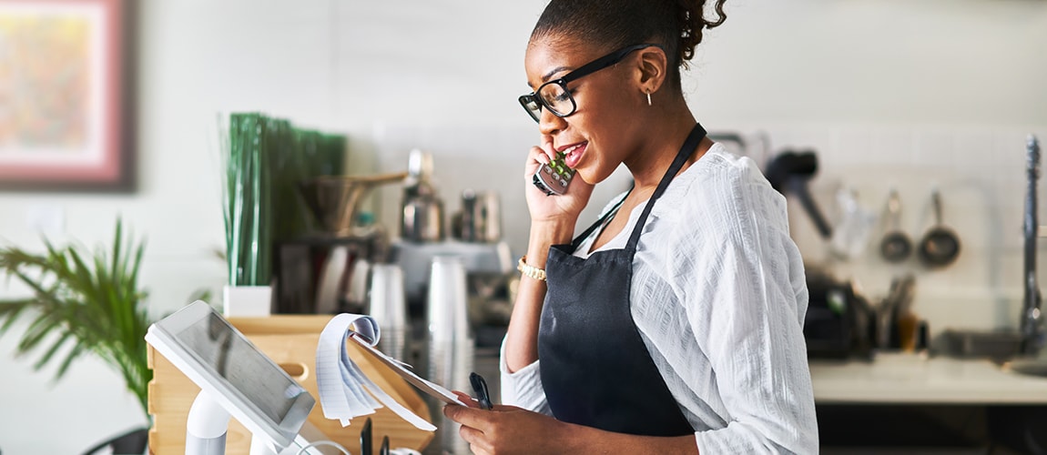 Young woman talking to a customer on the phone